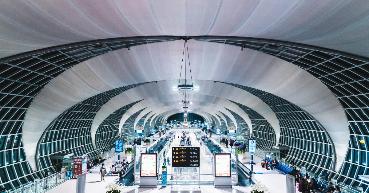 Wide shot of a busy transit terminal with people on the move getting ready to travel.