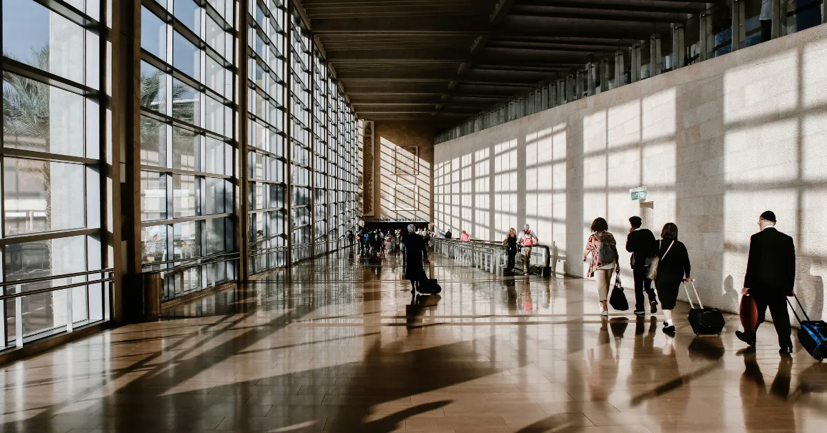 An airport terminal stretched out ahead, a visual of the long days that make you need to know how to keep wellness routines while traveling.