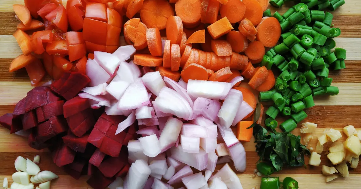 Colorful, freshly chopped vegetables arranged for cooking, representing a key healthy habit after 40 for staying healthy after 40.